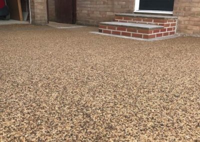 Resin bound driveway leading to back door, garage and garden path