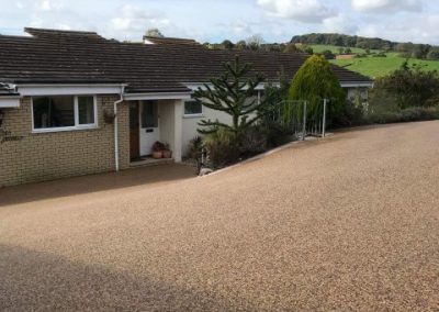 Large resin bound drive in Uplyme, Dorset. Crushed glass was scattered to provide much needed grip in the winter months